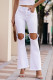 Белые рваные расклешенные джинсы с вырезами на коленях и бахромой