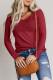 Top a maniche lunghe con scollo a V all'uncinetto in pizzo rosso