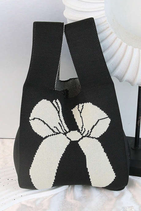 Bolso de mano de punto con diseño de lazo y bloques de color negro