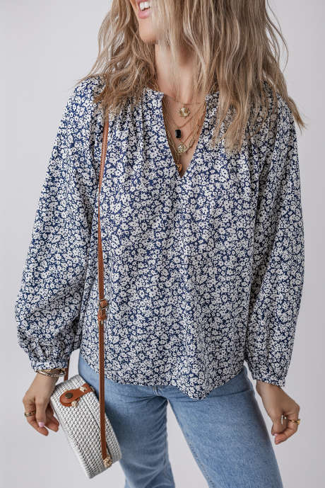 Blusa con escote en V, mangas abullonadas y estampado floral azul