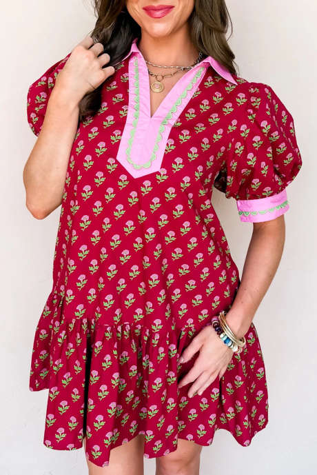 Röd blommig klänning med kontrasterande v-ringning och korta bubbelärmar