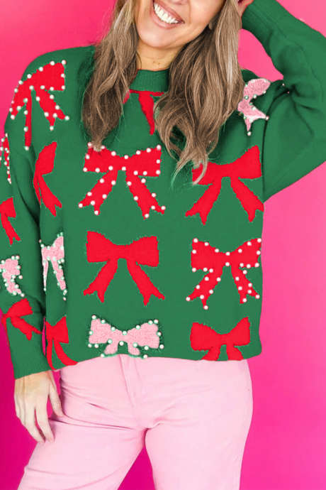 Pull de Noël vert foncé orné d'un nœud et de perles