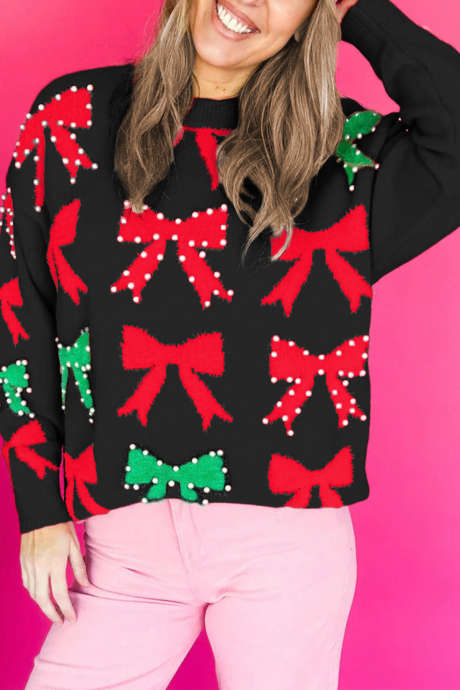 Pull de Noël orné d'un nœud noir et de perles