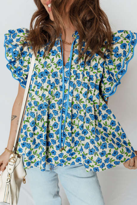 Błękitna bluzka z plisowanymi rękawami i kwiatowym wzorem