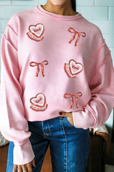 Różowa prążkowana bluzka z długim rękawem i cekinami, z kokardą i nadrukiem "Love Cake"