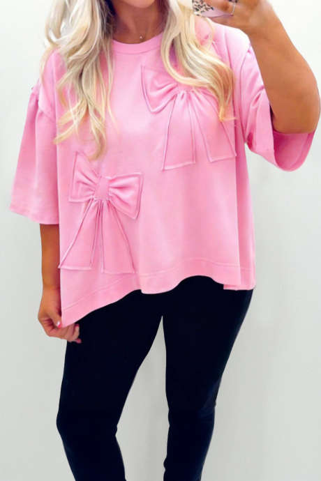 Różowa, jednokolorowa, luźna koszulka z kokardą i surowym brzegiem
