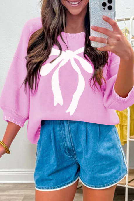 Sweter z falbanką i kokardą w kontrastowym kolorze z obniżonymi ramionami