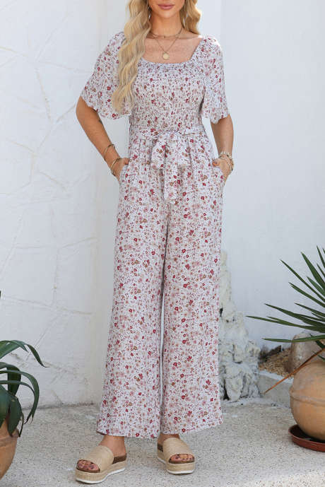 Witte jumpsuit met korte mouwen, wijde pijpen en smokwerk, bloemenprint