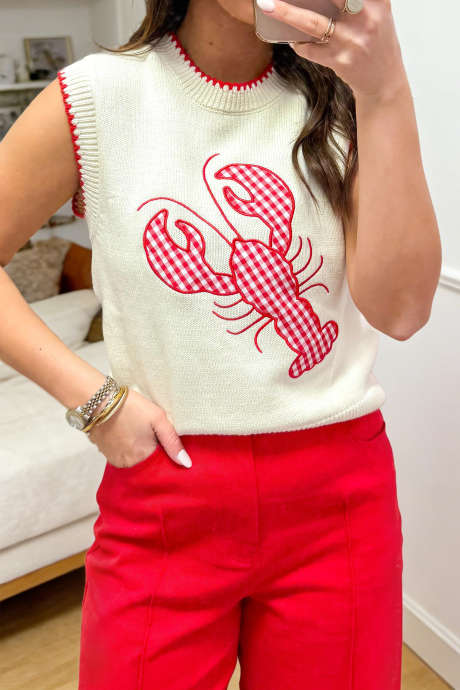 Pleteni pulover z okroglim izrezom in bež vzorcem karo