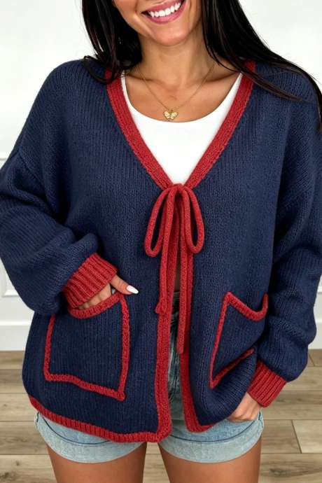 Áo cardigan len dáng rộng cổ chữ V màu xanh hải quân với viền tương phản, thắt nơ phía trước.
