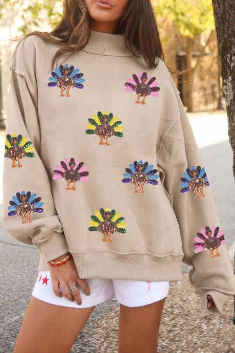 Abrikooskleurige sweatshirt met pailletten en kalkoenmotief, met zichtbare naden, voor Thanksgiving.