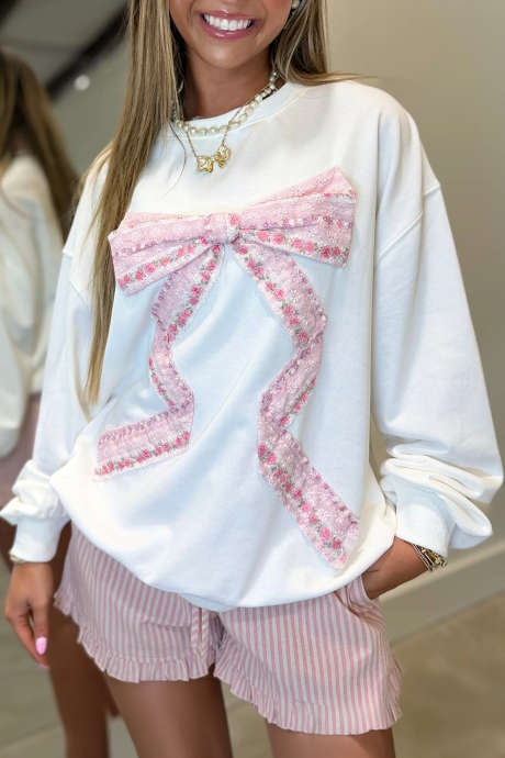 Weißes Langarmshirt mit Blumenmuster und Schleifenverzierung, überschnittenen Schultern und langen Ärmeln