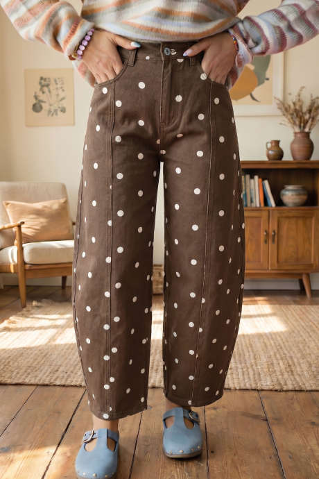 Calça jeans casual marrom com estampa de bolinhas e costuras ajustadas.