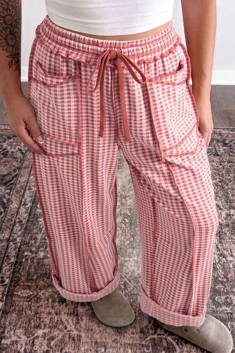 Calça de corte reto com detalhes contrastantes em xadrez vermelho, cordão e cintura elástica.