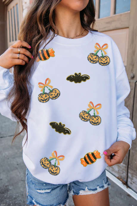 Witte trui met pailletten en Halloween-print.