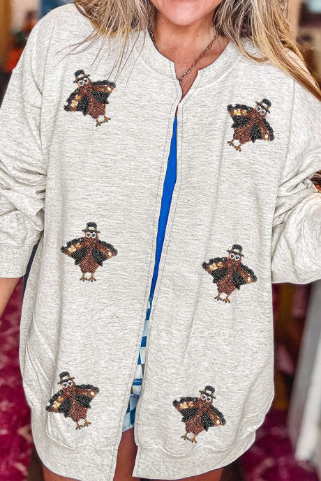 Lichtgrijze casual sweater met pailletten en kalkoenprint, open voorkant en zakken.